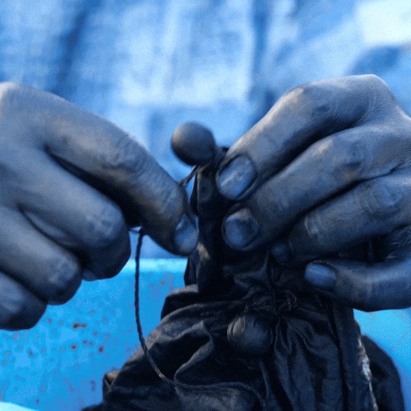 Close detail of hand-dyed indigo cloth, showing natural variation in tone.