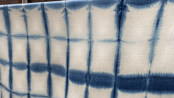 Close detail of hand-dyed indigo cloth, showing natural variation in tone.