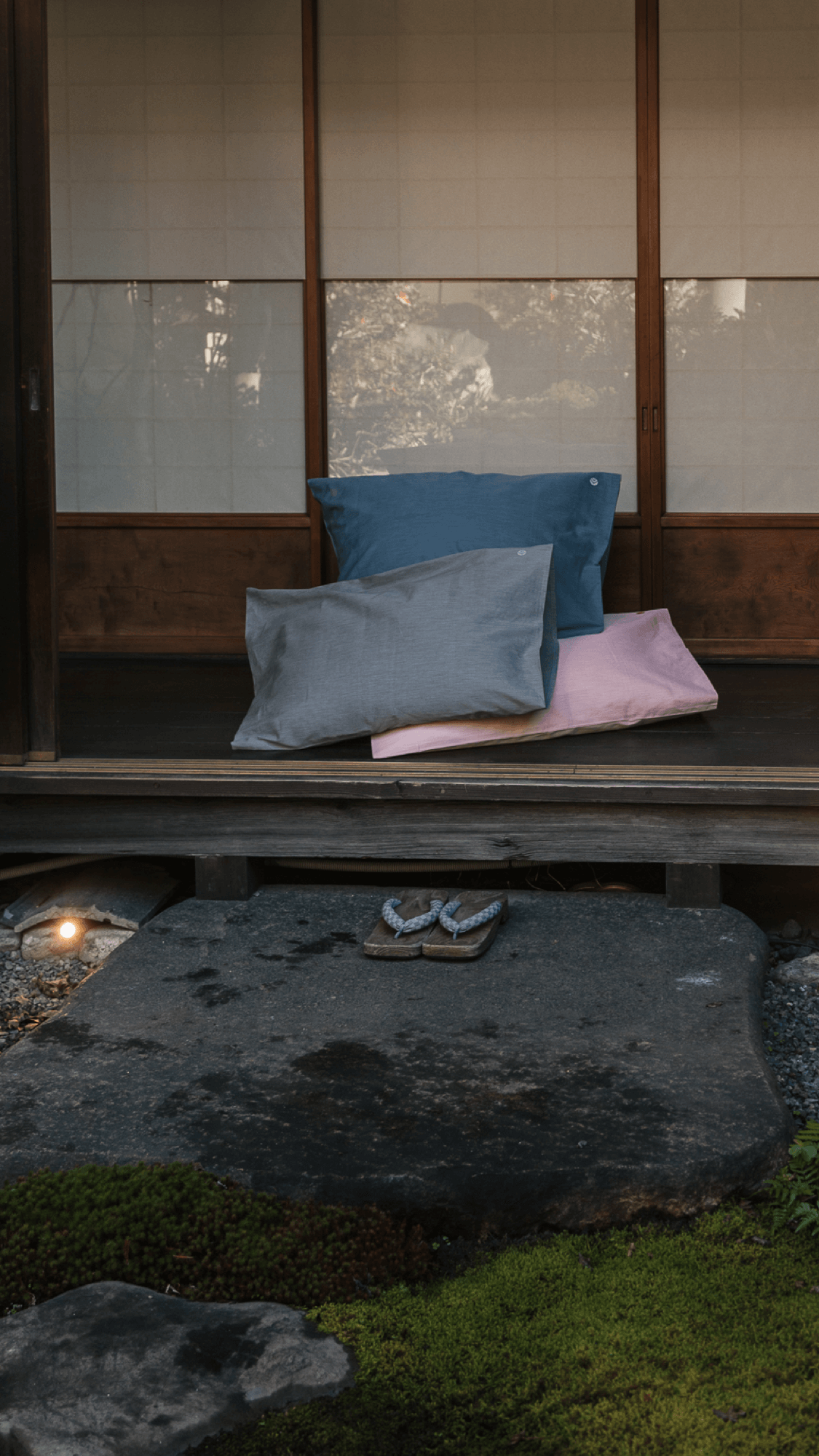 Aizome Pillowcases in three different colour ways are standing in front ja traditional japanese building